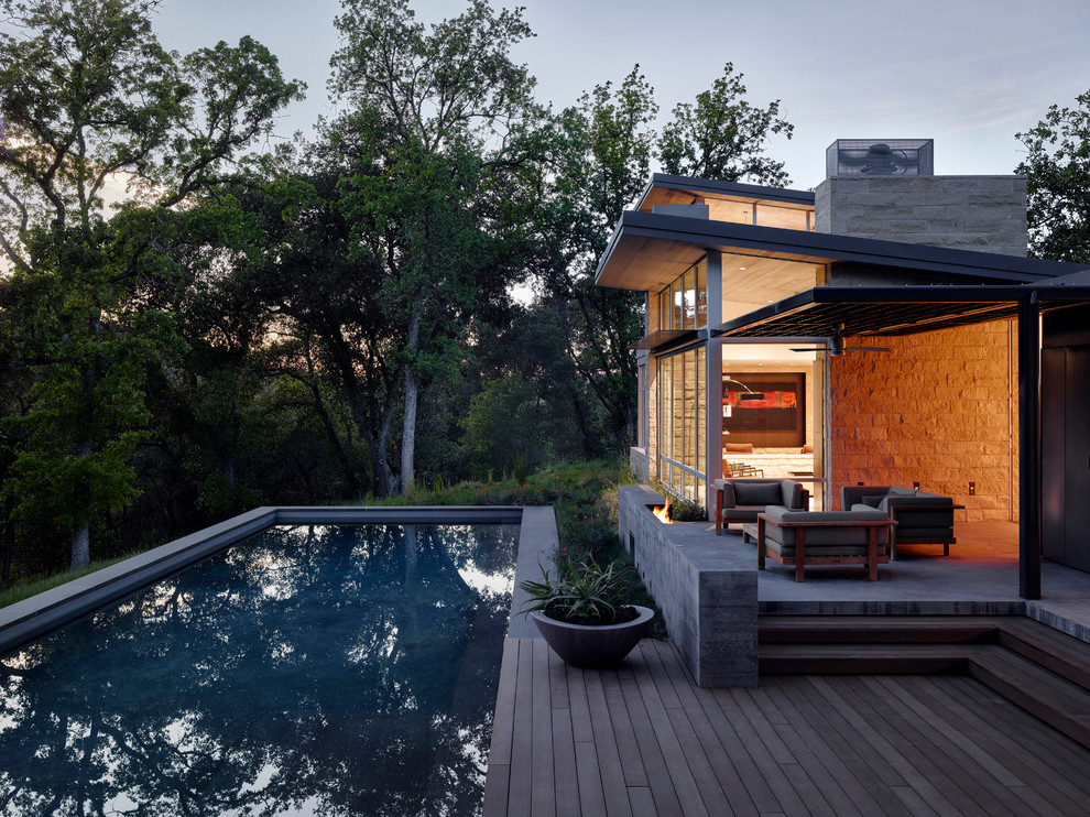 Design ideas for a contemporary backyard rectangular lap pool in Sacramento with decking.