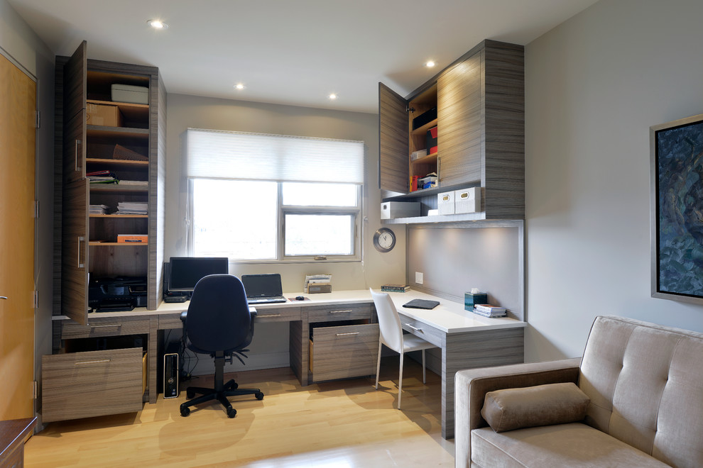 Inspiration for a modern home office in Toronto with beige walls and a built-in desk.
