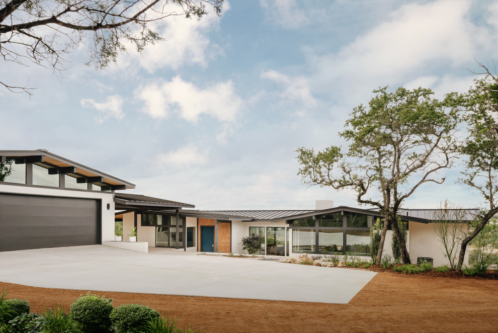 Inspiration for a mid-sized 1960s white one-story house exterior remodel in San Francisco with a shed roof and a gray roof