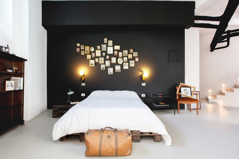 Design ideas for a contemporary bedroom in Milan with black walls, concrete floors and white floor.