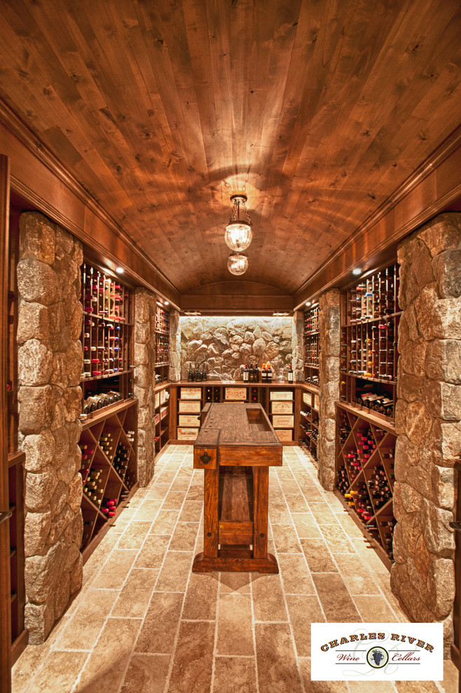 Design ideas for a traditional wine cellar in Boston with travertine floors and diamond bins.
