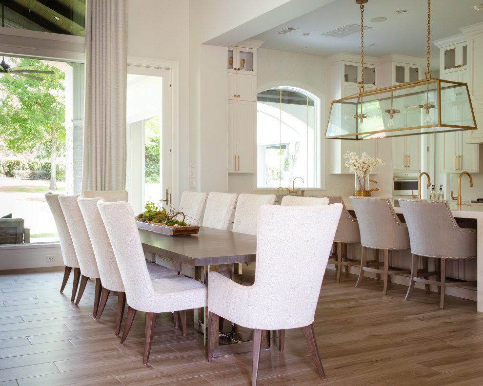 Kitchen/dining room combo - transitional porcelain tile and brown floor kitchen/dining room combo idea in Houston with white walls