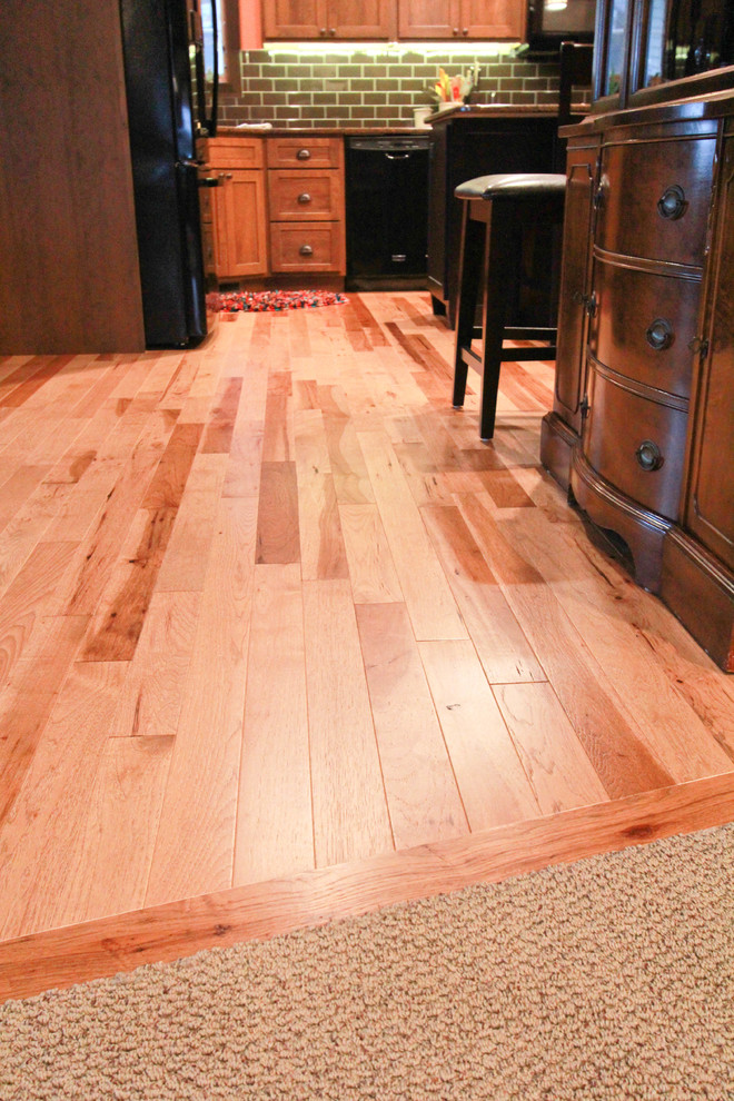 Transitional light wood floor eat-in kitchen photo with green backsplash, subway tile backsplash and an island