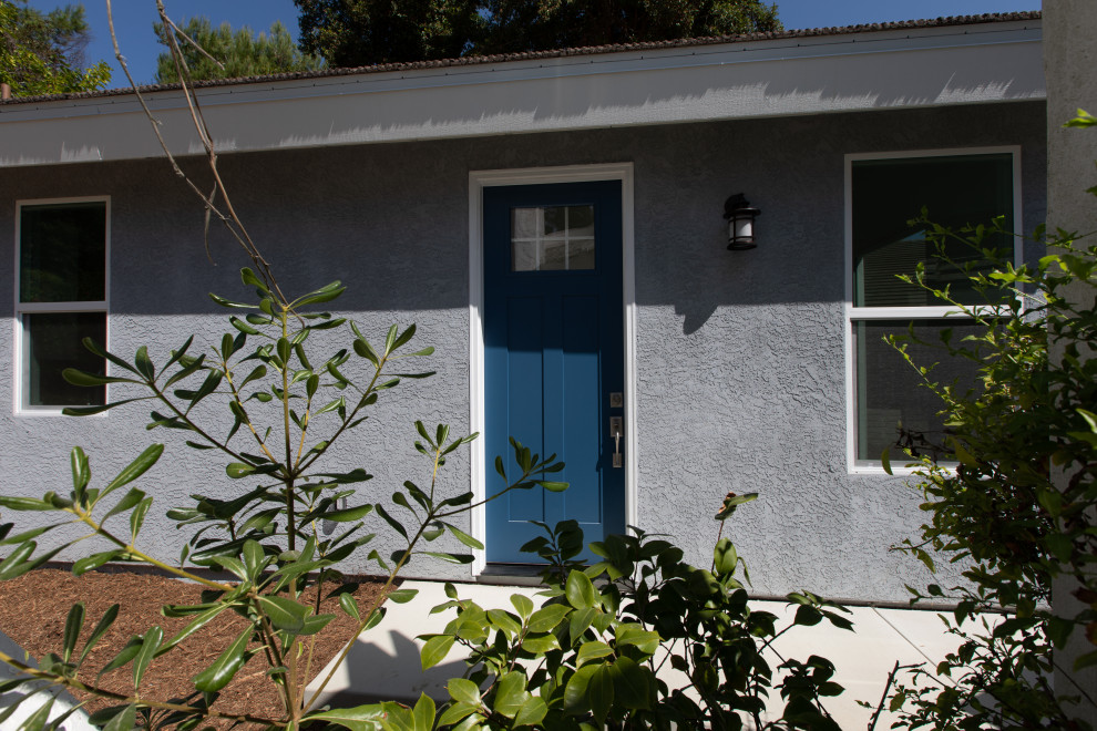 Small beach style front door in San Diego with grey walls, a single front door and a blue front door.