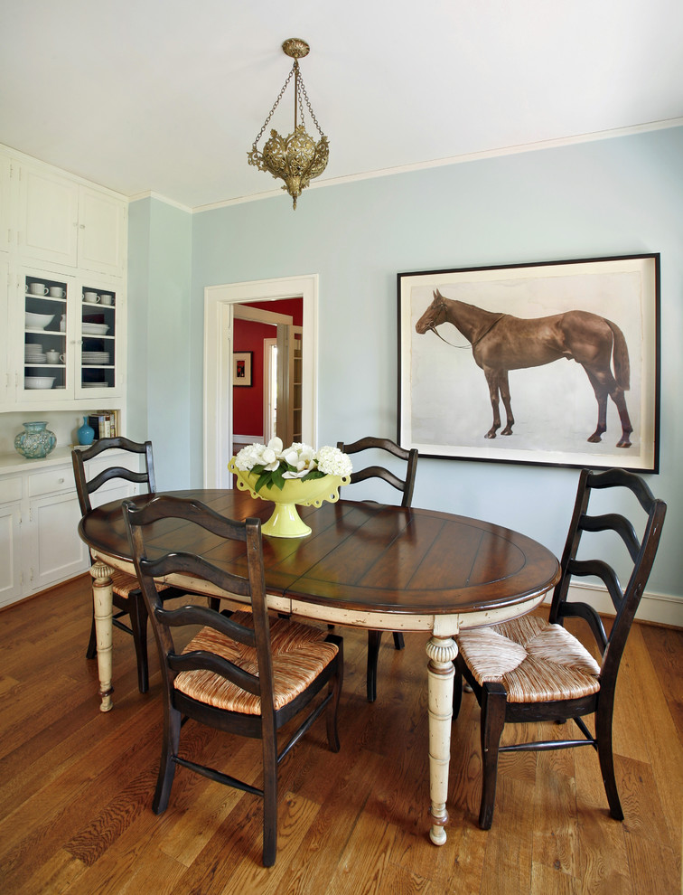 Photo of a mid-sized traditional separate dining room in Dallas with blue walls, dark hardwood floors and no fireplace.