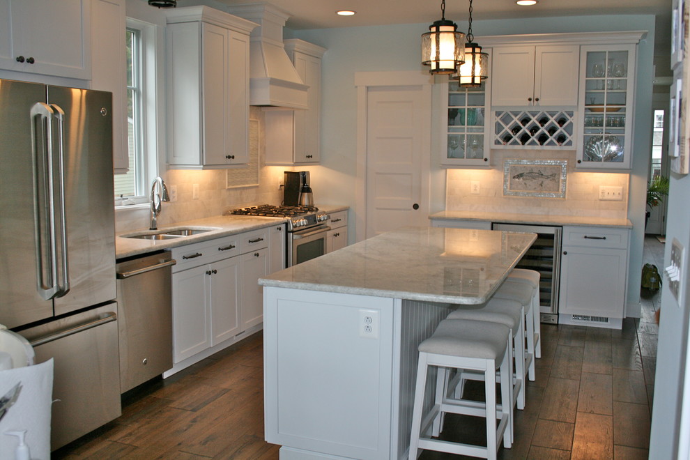 Example of a kitchen design in DC Metro with recessed-panel cabinets and white cabinets