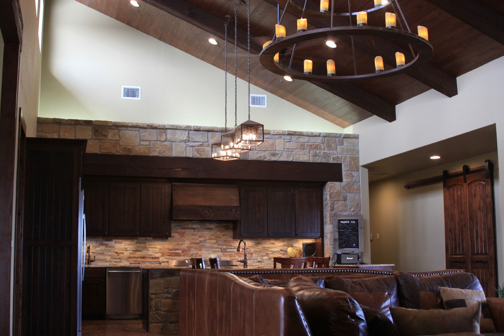 Inspiration for a rustic galley concrete floor open concept kitchen remodel in Austin with a farmhouse sink, beaded inset cabinets, dark wood cabinets, granite countertops, stainless steel appliances and a peninsula