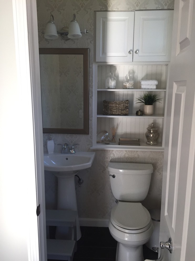 Design ideas for a small traditional 3/4 bathroom in Providence with raised-panel cabinets, white cabinets, a two-piece toilet, beige walls, dark hardwood floors, a pedestal sink, solid surface benchtops and brown floor.