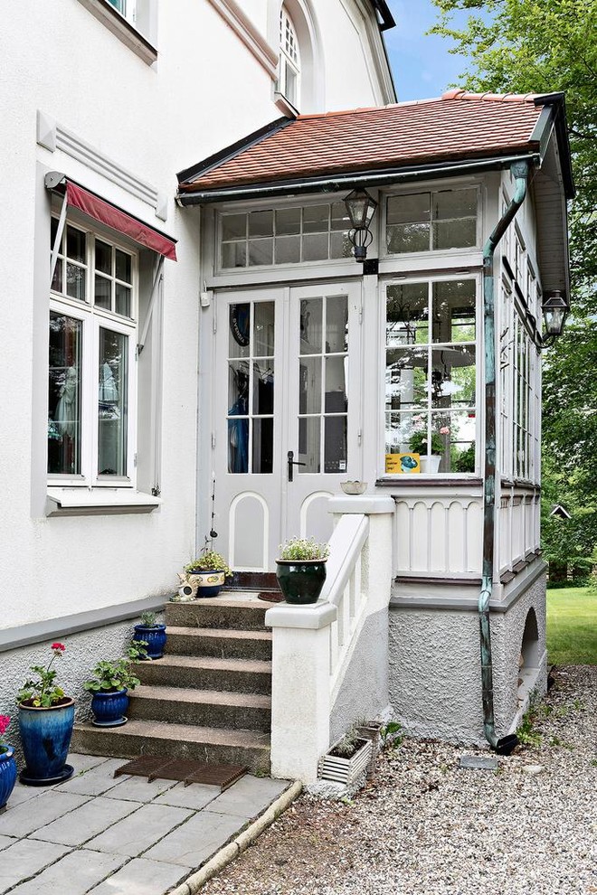 This is an example of a mid-sized country vestibule in Stockholm with white walls, a double front door and a white front door.