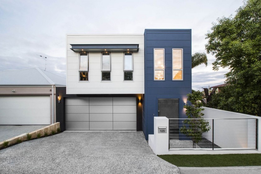 Inspiration for a mid-sized modern two-storey blue townhouse exterior in Perth with a flat roof, concrete fiberboard siding and a metal roof.