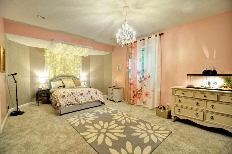 Large transitional bedroom in Other with pink walls, carpet and beige floor.