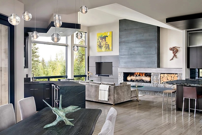Expansive modern open concept living room in Other with a home bar, grey walls, marble floors, a wood stove, a stone fireplace surround, a wall-mounted tv and beige floor.