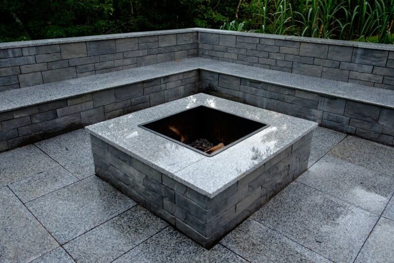 Photo of a mid-sized contemporary backyard patio in Other with a fire feature, concrete pavers and no cover.