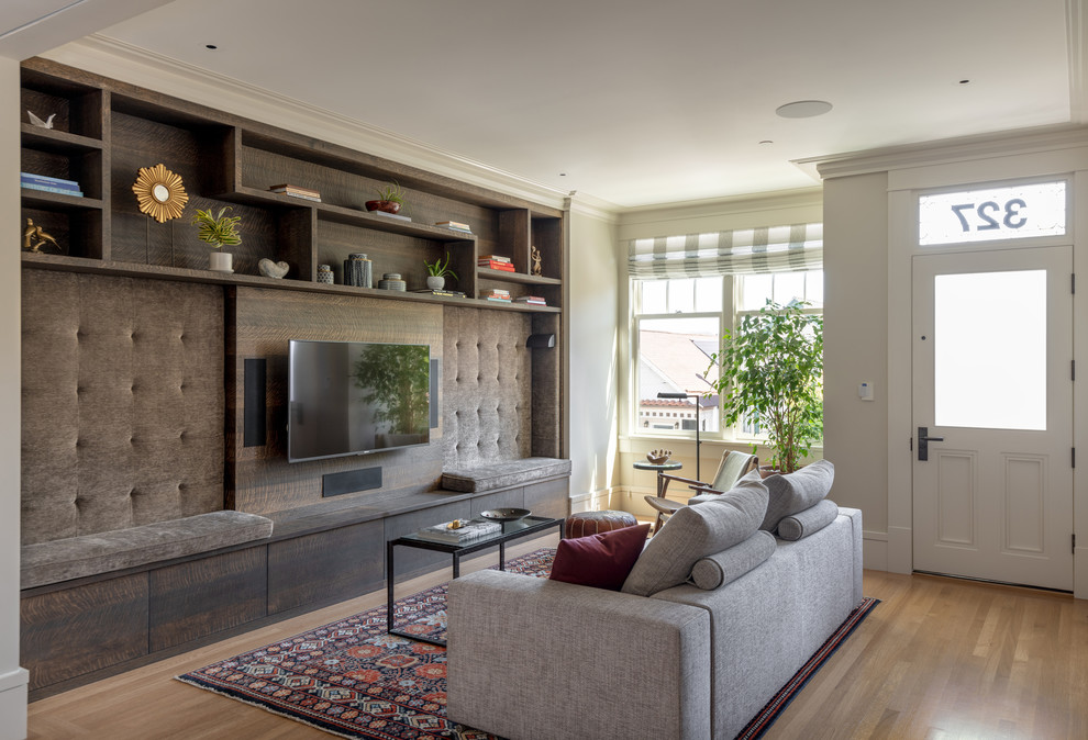 Transitional open concept medium tone wood floor and brown floor living room photo in San Francisco with a wall-mounted tv and beige walls