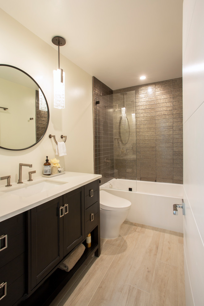Photo of a small transitional 3/4 bathroom in San Francisco with furniture-like cabinets, brown cabinets, a drop-in tub, a shower/bathtub combo, a bidet, brown tile, glass tile, white walls, wood-look tile, an undermount sink, engineered quartz benchtops, beige floor, an open shower, white benchtops, a niche, a single vanity and a freestanding vanity.
