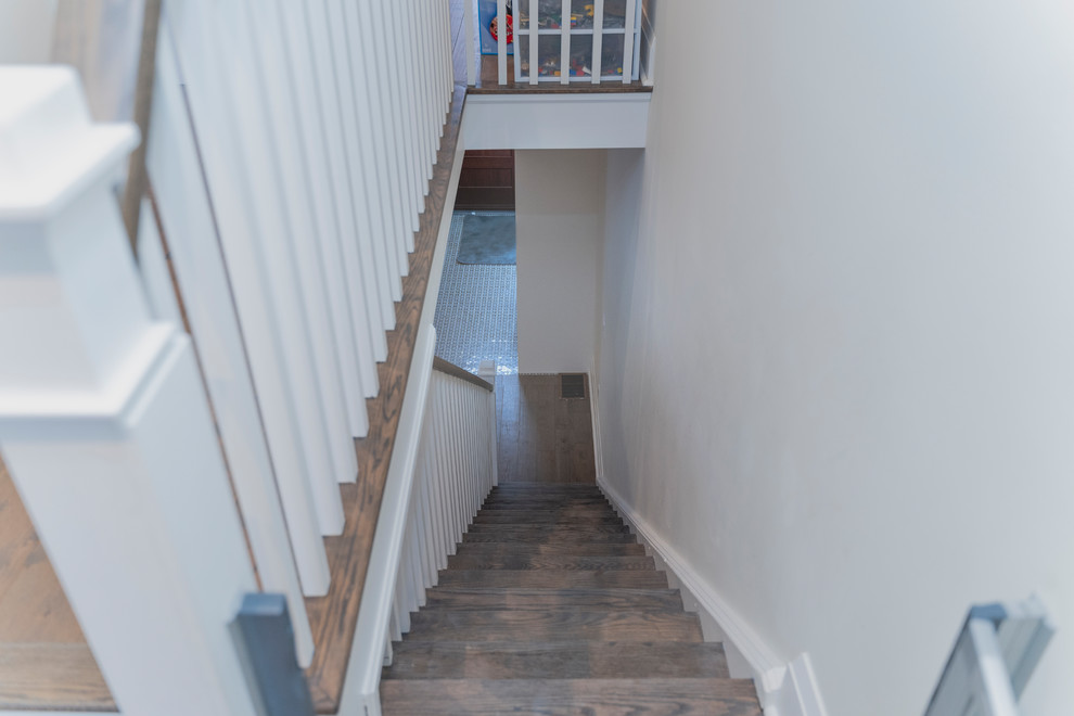 Photo of a mid-sized contemporary wood straight staircase with wood risers and wood railing.