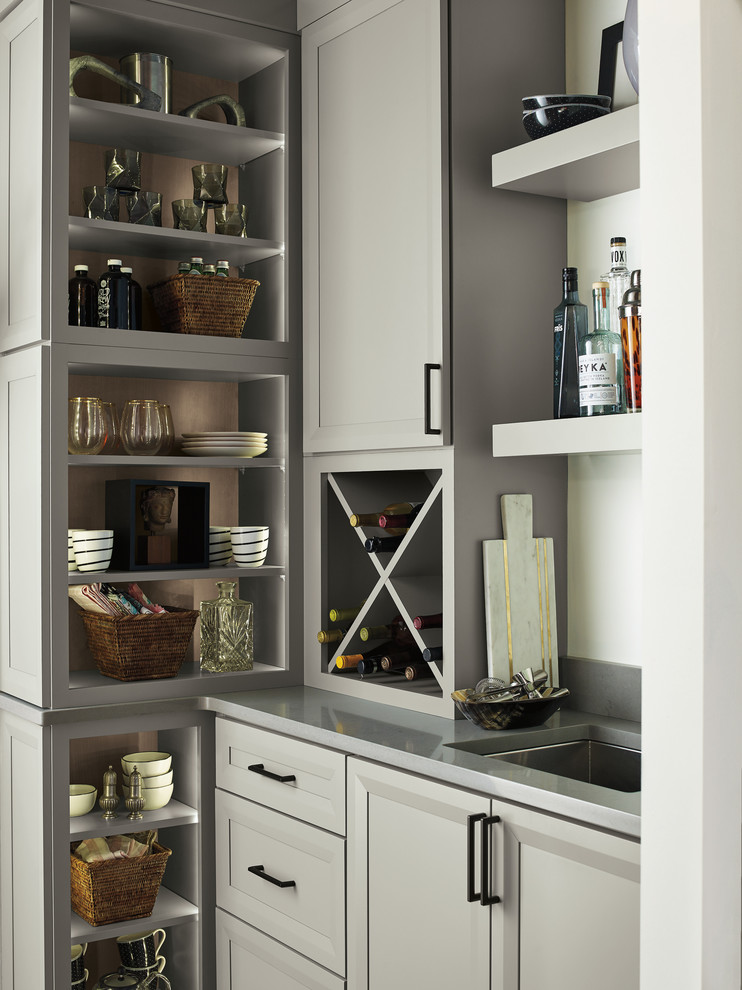 Photo of a small transitional wet bar in Other with an integrated sink and grey benchtop.
