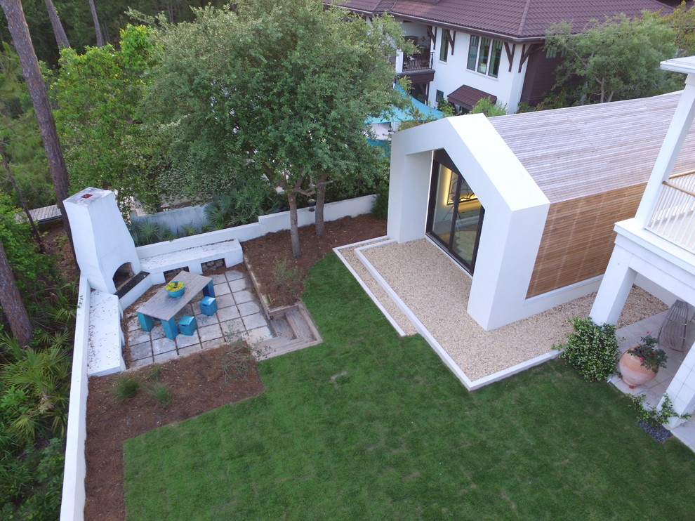 Small contemporary one-storey white exterior in Miami with wood siding and a gable roof.