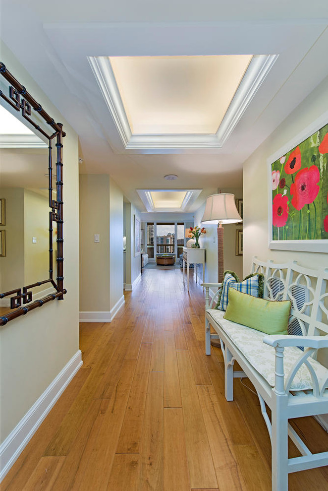 Photo of a transitional hallway in Miami with beige walls, medium hardwood floors and yellow floor.