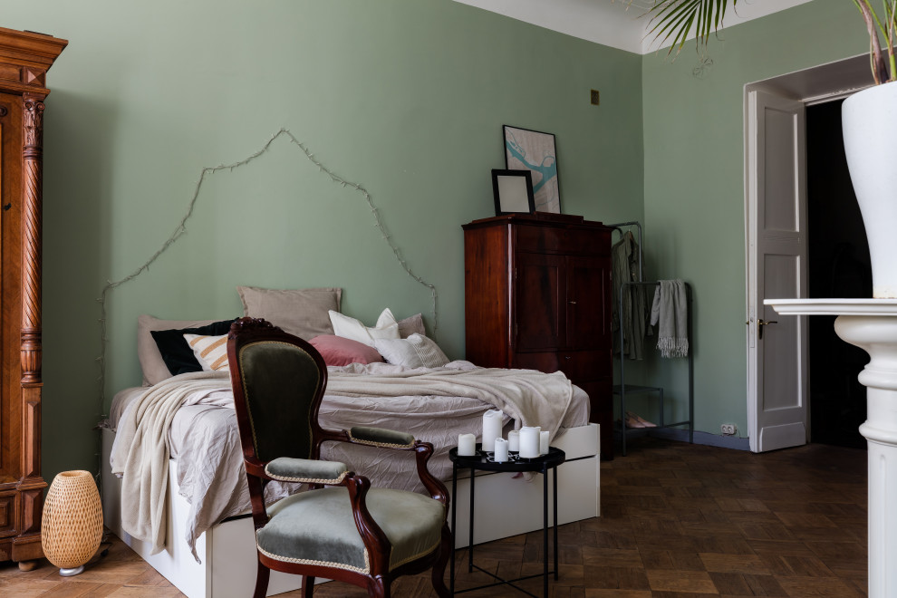 Inspiration for a large eclectic master medium tone wood floor and brown floor bedroom remodel in Saint Petersburg with green walls