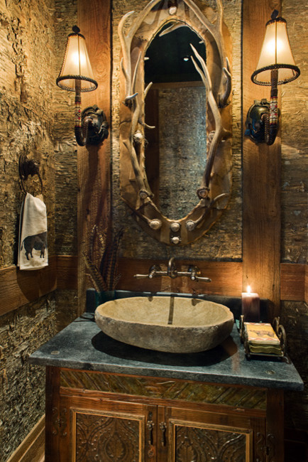 Inspiration for a mid-sized country powder room in Other with raised-panel cabinets, distressed cabinets, brown walls, a vessel sink and marble benchtops.