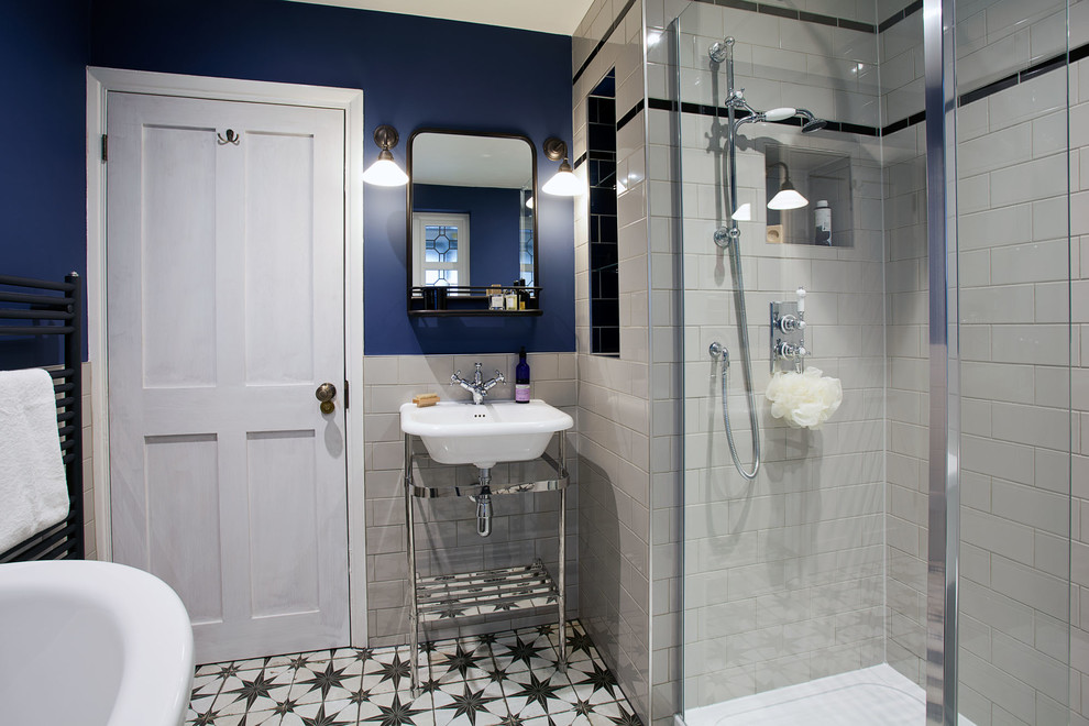 Inspiration for a mid-sized eclectic kids bathroom in Surrey with a freestanding tub, an open shower, a two-piece toilet, white tile, porcelain tile, blue walls, ceramic floors, a console sink, multi-coloured floor and an open shower.