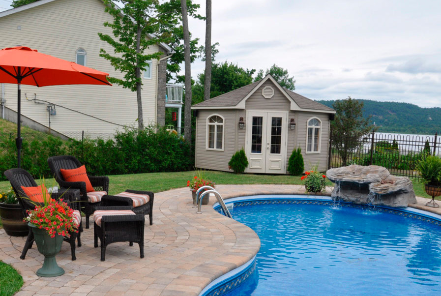 Mid-sized transitional backyard brick and kidney-shaped pool photo