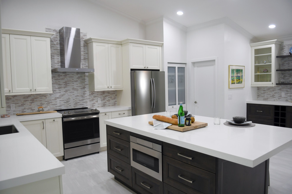 Photo of a mid-sized transitional l-shaped open plan kitchen in Miami with an undermount sink, shaker cabinets, white cabinets, quartz benchtops, multi-coloured splashback, ceramic splashback, stainless steel appliances, porcelain floors, with island, white floor and white benchtop.