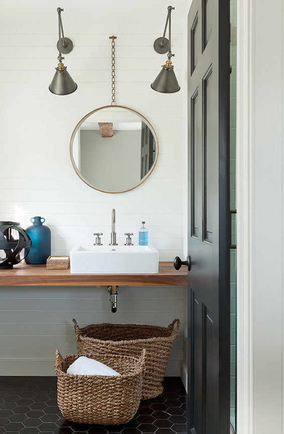 Small beach style 3/4 bathroom in New York with open cabinets, medium wood cabinets, an alcove shower, a one-piece toilet, black tile, stone tile, white walls, marble floors, a vessel sink and wood benchtops.