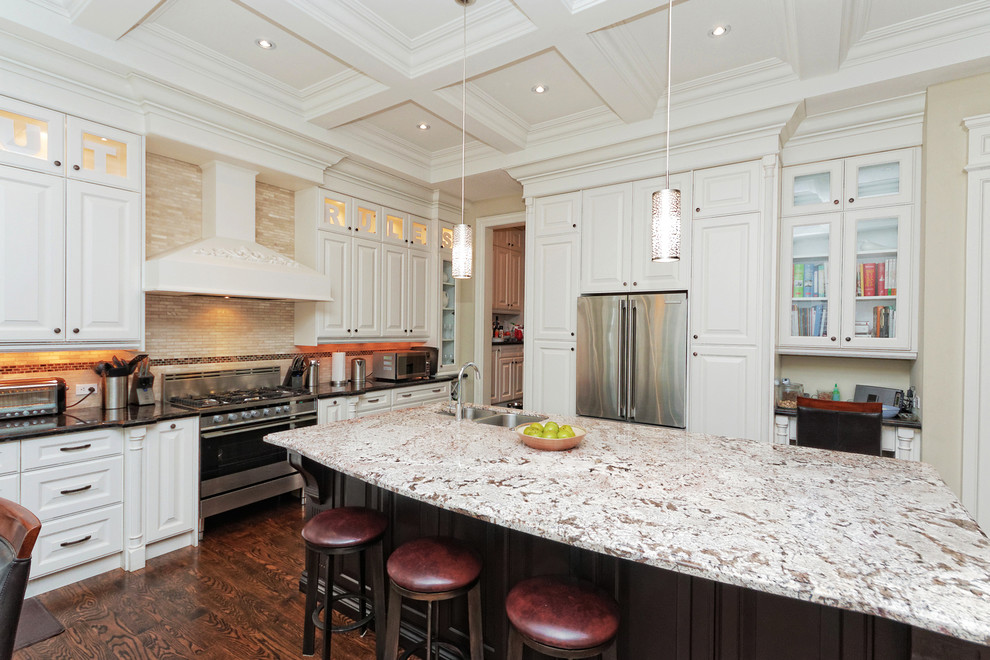 Inspiration for a large transitional single-wall dark wood floor and brown floor kitchen remodel in Toronto with a double-bowl sink, raised-panel cabinets, white cabinets, granite countertops, beige backsplash, stainless steel appliances and an island