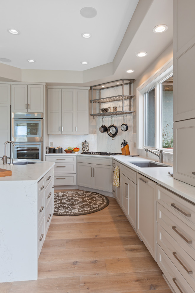Inspiration for a mid-sized contemporary l-shaped separate kitchen in Seattle with a double-bowl sink, beaded inset cabinets, grey cabinets, quartz benchtops, white splashback, engineered quartz splashback, stainless steel appliances, light hardwood floors, with island, beige floor, white benchtop and coffered.