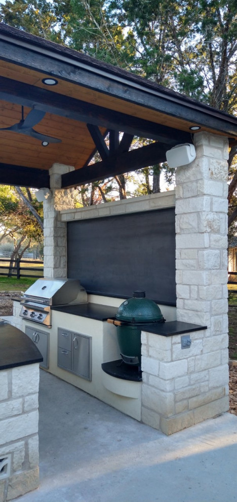 Design ideas for a large back patio in Austin with an outdoor kitchen and a gazebo.