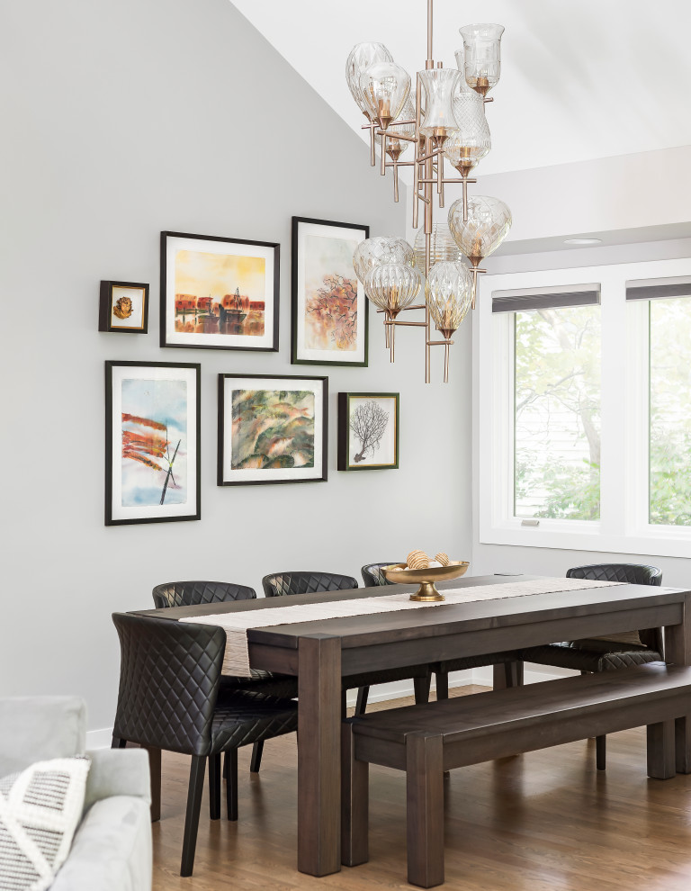 Inspiration for a large transitional open concept medium tone wood floor dining room remodel in Chicago with gray walls, a standard fireplace and a tile fireplace
