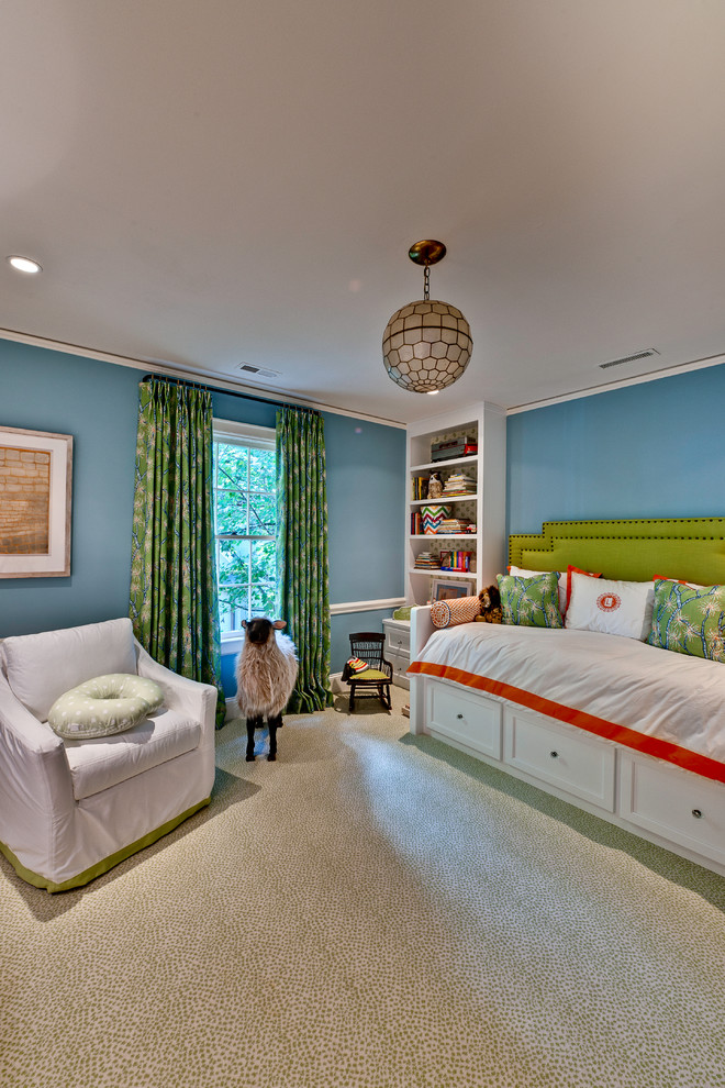 This is an example of an eclectic gender-neutral kids' bedroom for kids 4-10 years old in Charlotte with blue walls and carpet.