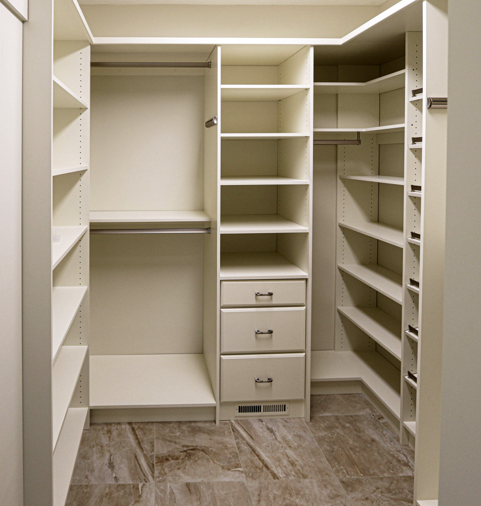 Design ideas for a mid-sized transitional walk-in wardrobe in Cleveland with beige cabinets, ceramic floors and beige floor.