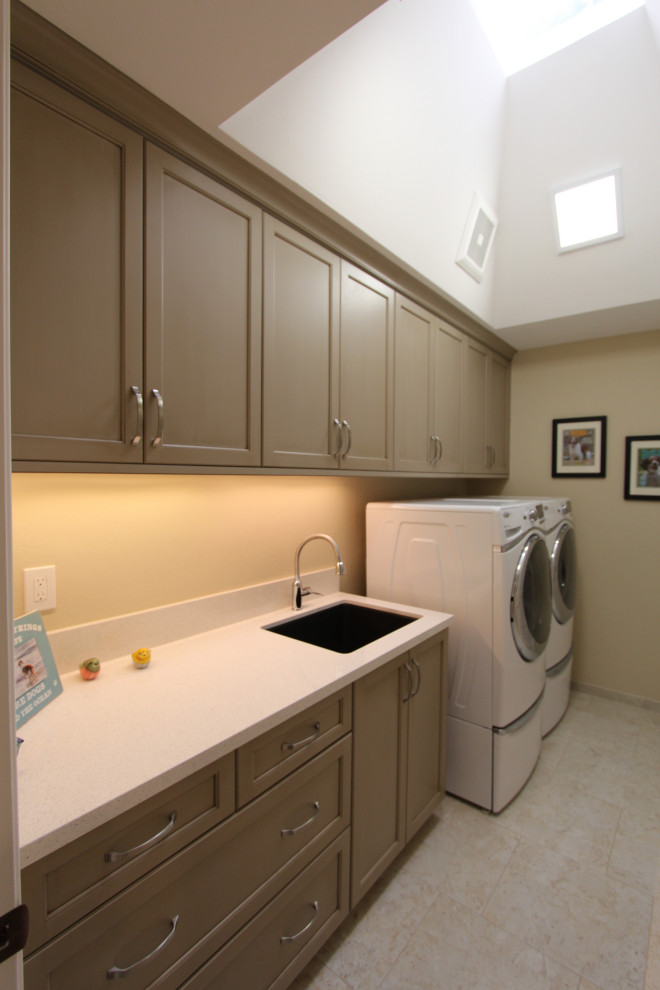Mid-sized transitional galley dedicated laundry room in San Francisco with an undermount sink, recessed-panel cabinets, beige cabinets, quartz benchtops, white splashback, stone slab splashback, beige walls, porcelain floors, a side-by-side washer and dryer, beige floor, white benchtop and vaulted.