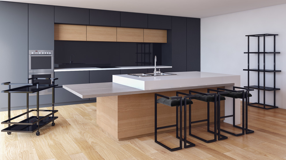 Large modern eat-in kitchen in New York with a double-bowl sink, flat-panel cabinets, grey cabinets, concrete benchtops, black splashback, glass sheet splashback, stainless steel appliances, bamboo floors and with island.