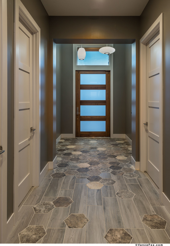 Front door - small contemporary ceramic tile and gray floor front door idea with gray walls and a dark wood front door