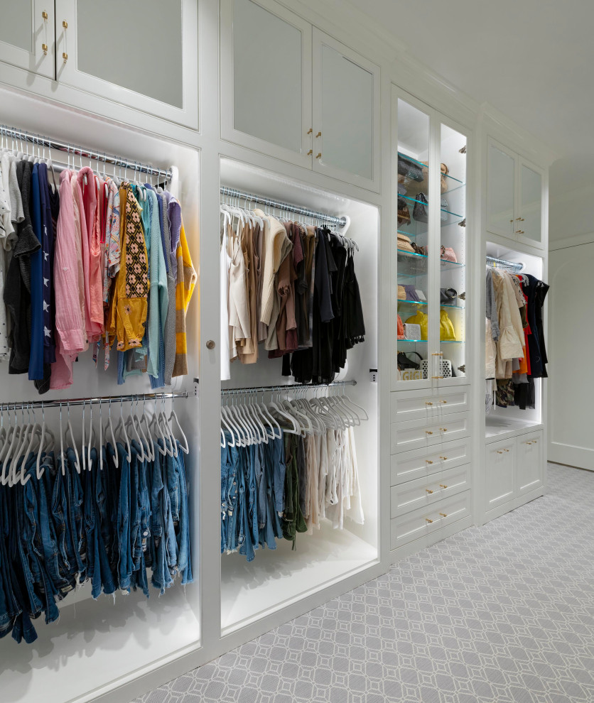 This is an example of a medium sized classic gender neutral walk-in wardrobe in Dallas with beaded cabinets, white cabinets, carpet and grey floors.