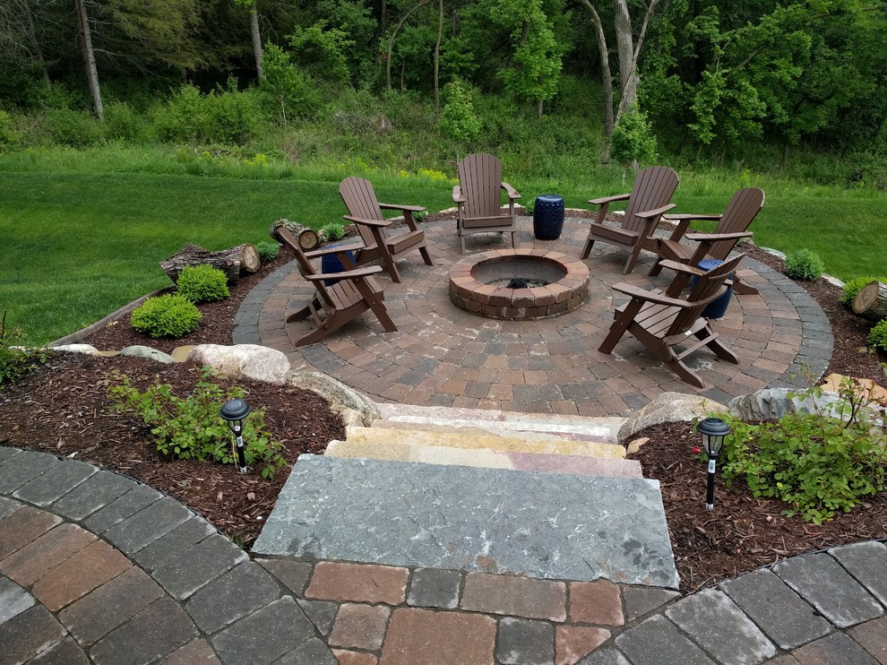 Inspiration for a mid-sized timeless backyard concrete paver patio remodel in Minneapolis with a fire pit and no cover