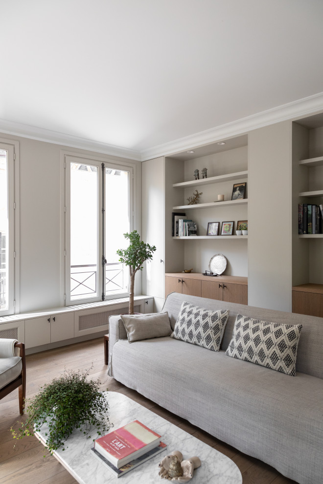 Design ideas for a large contemporary grey and white open plan living room in Paris with a reading nook, grey walls, medium hardwood flooring, no tv and brown floors.