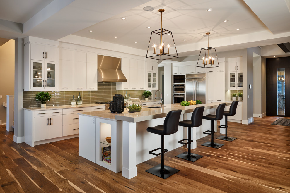 Inspiration for a huge transitional medium tone wood floor kitchen pantry remodel in Calgary with flat-panel cabinets, white cabinets, glass tile backsplash and an island