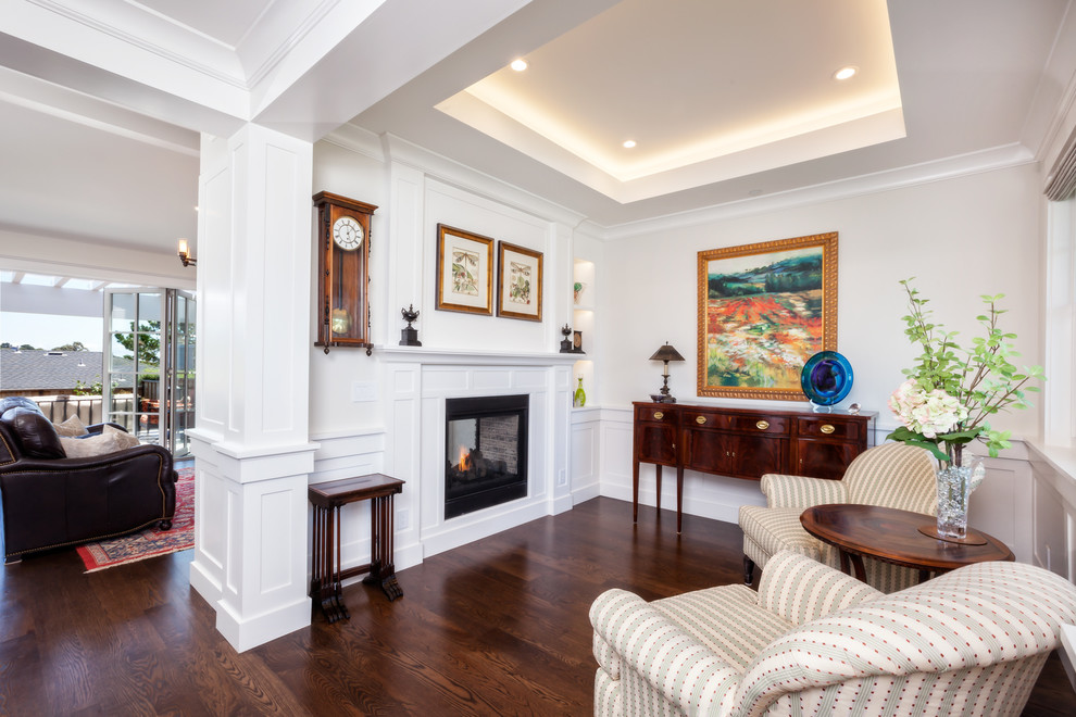 Inspiration for a mid-sized transitional formal open concept living room in San Francisco with white walls, a two-sided fireplace, dark hardwood floors, a wood fireplace surround, no tv, brown floor and recessed.