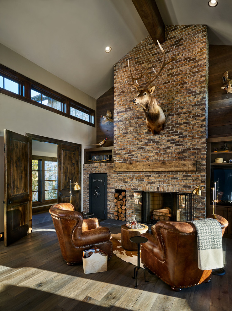 Large country living room in Portland with white walls, a standard fireplace, a brick fireplace surround, dark hardwood floors and brown floor.