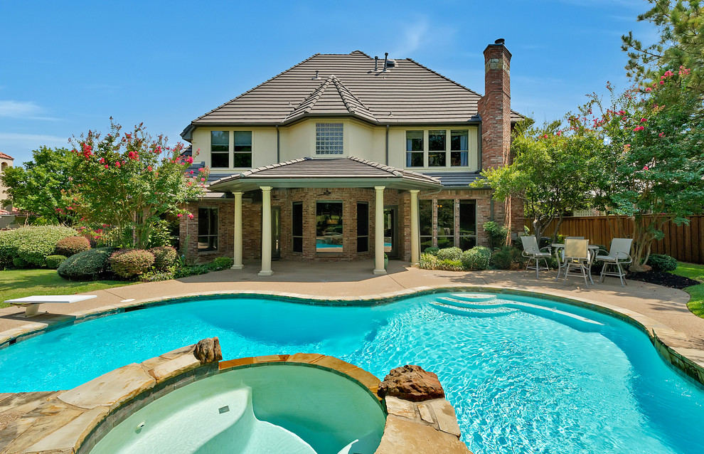 Inspiration for a traditional backyard custom-shaped pool in Dallas.