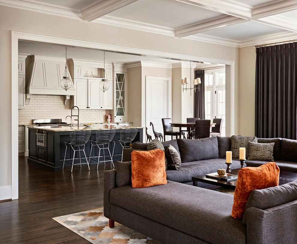 Contemporary open concept living room in Raleigh with beige walls and dark hardwood floors.