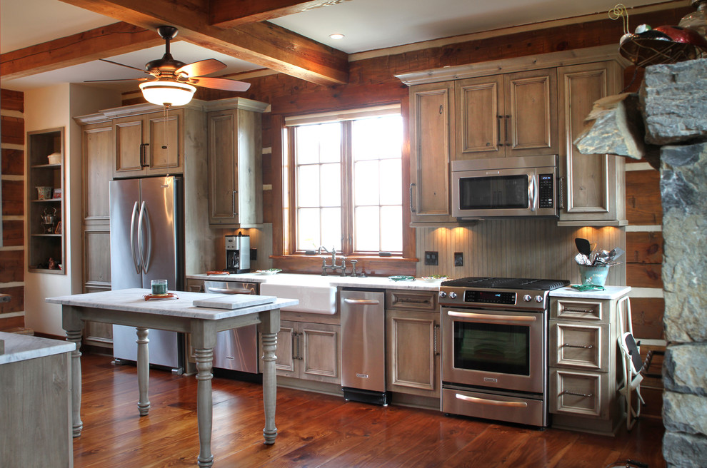 Inspiration for a mid-sized country single-wall open plan kitchen in Other with a farmhouse sink, recessed-panel cabinets, distressed cabinets, marble benchtops, green splashback, stainless steel appliances, medium hardwood floors and multiple islands.