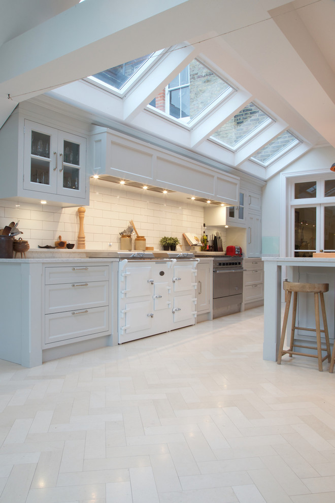 Photo of a modern kitchen in London with limestone floors.