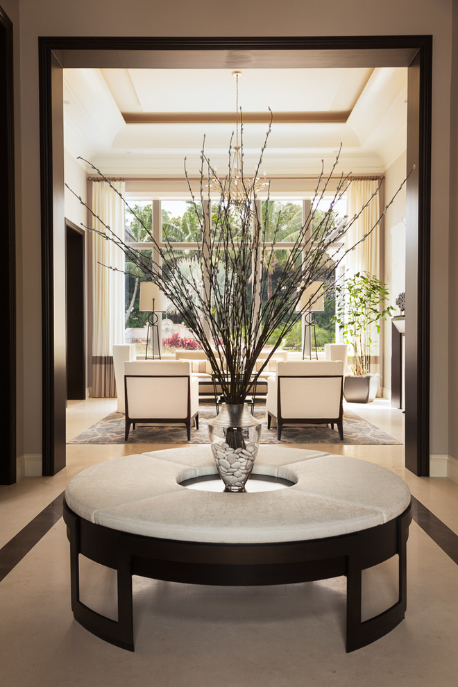 Example of a mid-sized transitional ceramic tile and beige floor foyer design in Miami with beige walls
