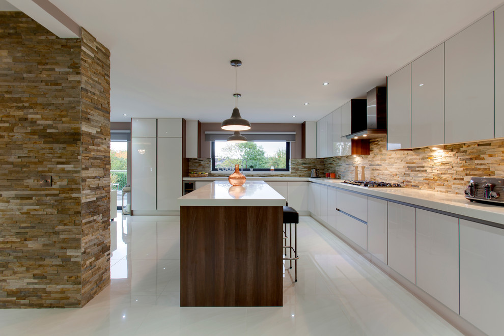 Inspiration for a large contemporary l-shaped open plan kitchen in Other with a drop-in sink, flat-panel cabinets, white cabinets, quartzite benchtops, stone tile splashback, stainless steel appliances, porcelain floors and with island.